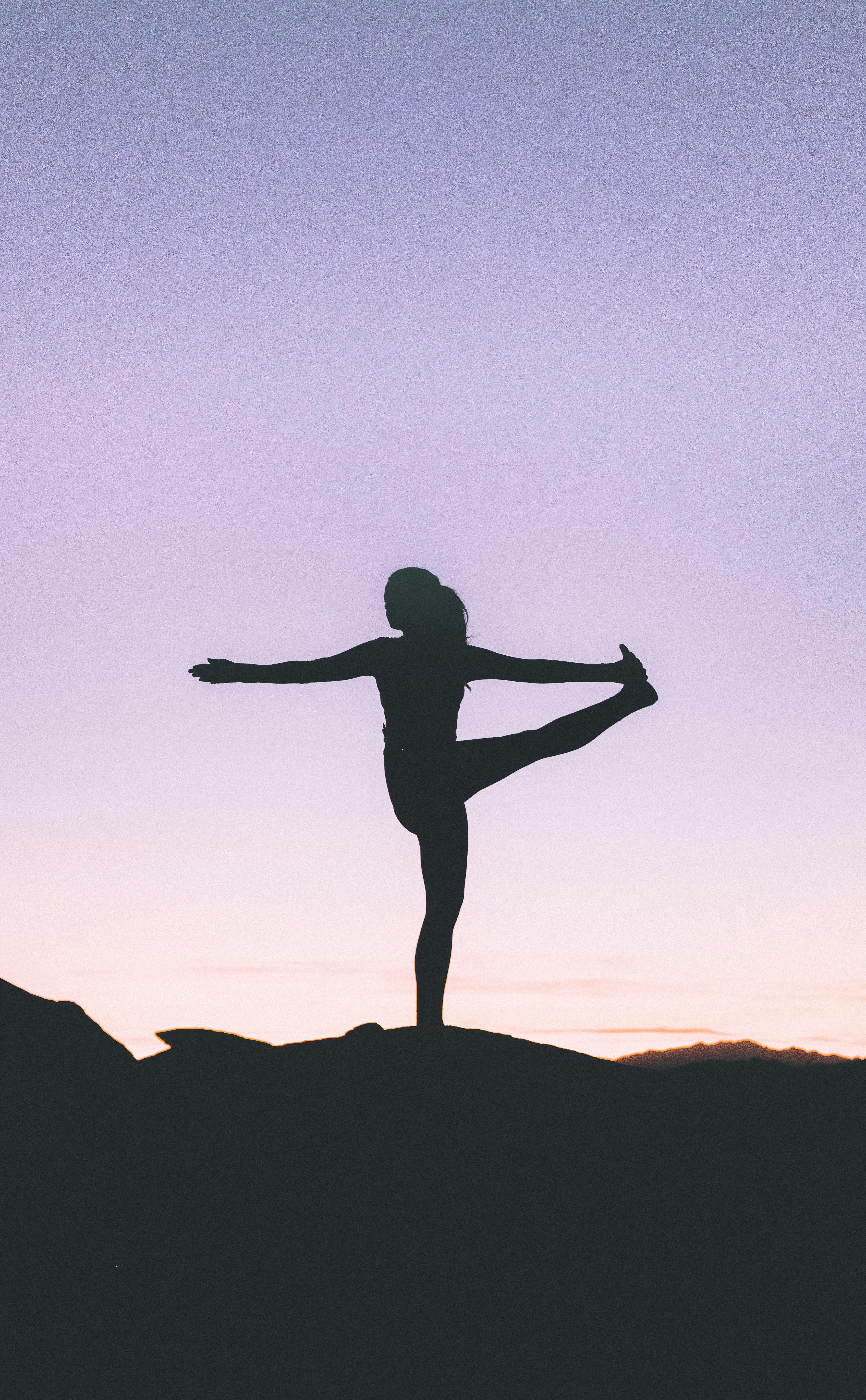 Gentle yoga sequence on a mat in a dark green studio
